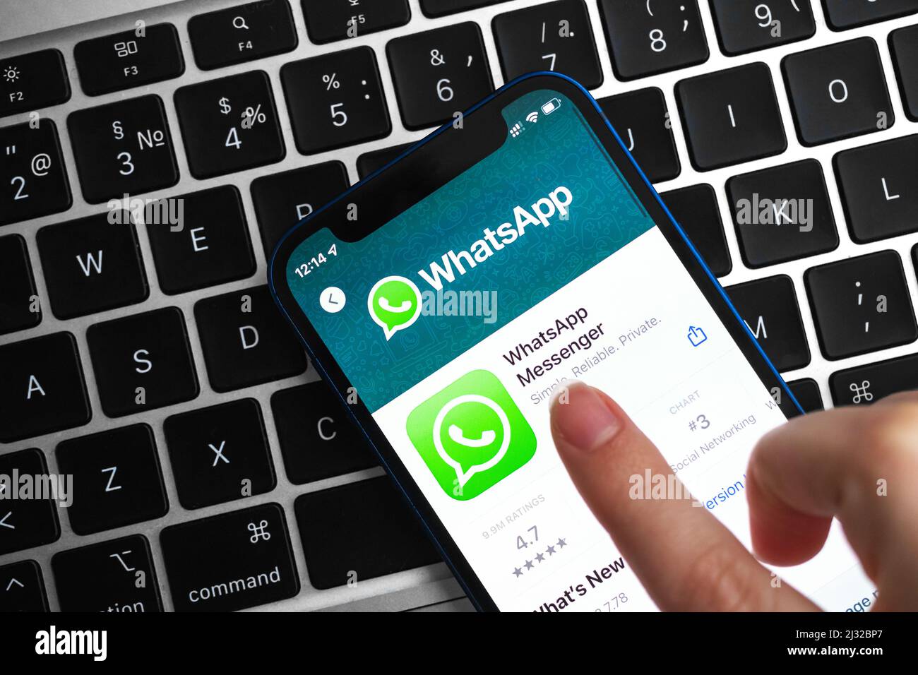 Donna che installa l'app Whatsapp. Mano con telefono cellulare con applicazione. Messenger e social networking concept foto Foto Stock