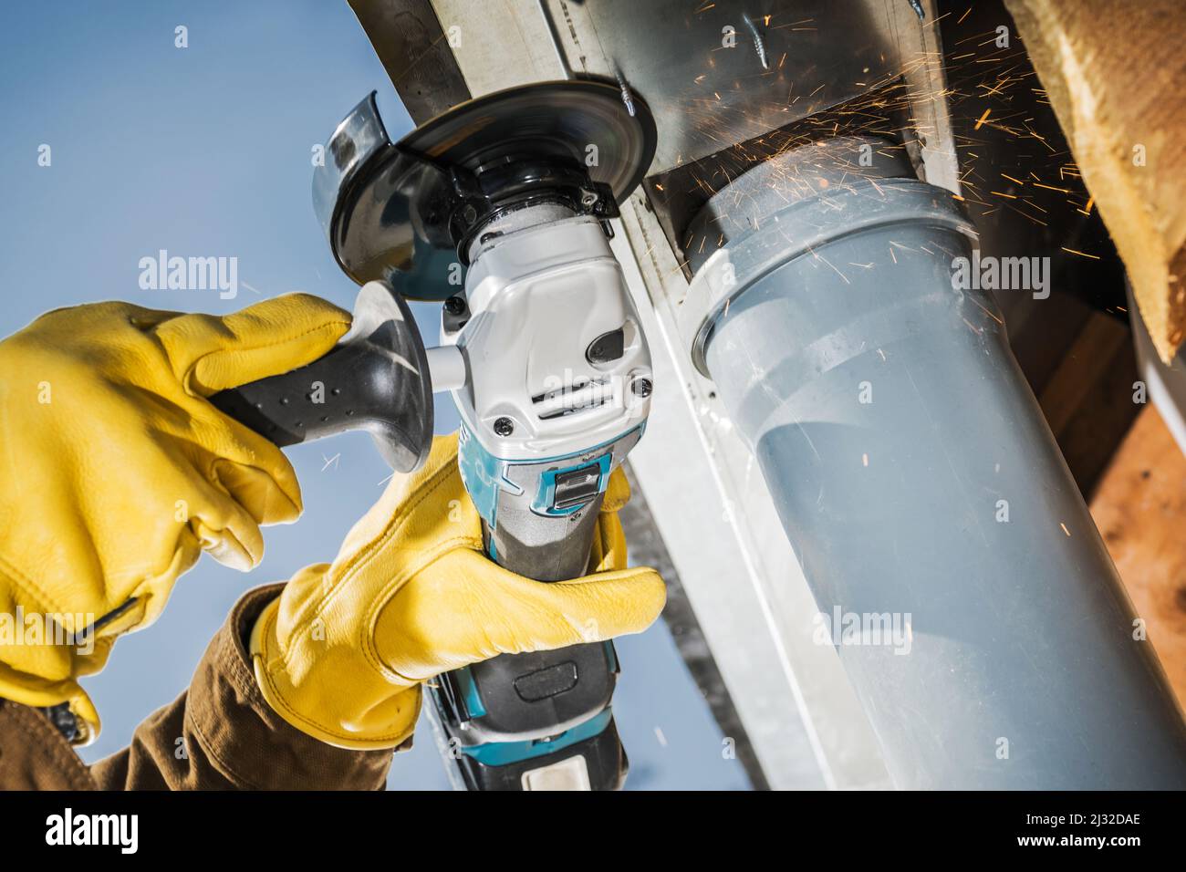 Tema dell'industria delle costruzioni. Utensile elettrico per sega circolare cordless in azione. Operatore che taglia gli elementi metallici in primo piano. Foto Stock