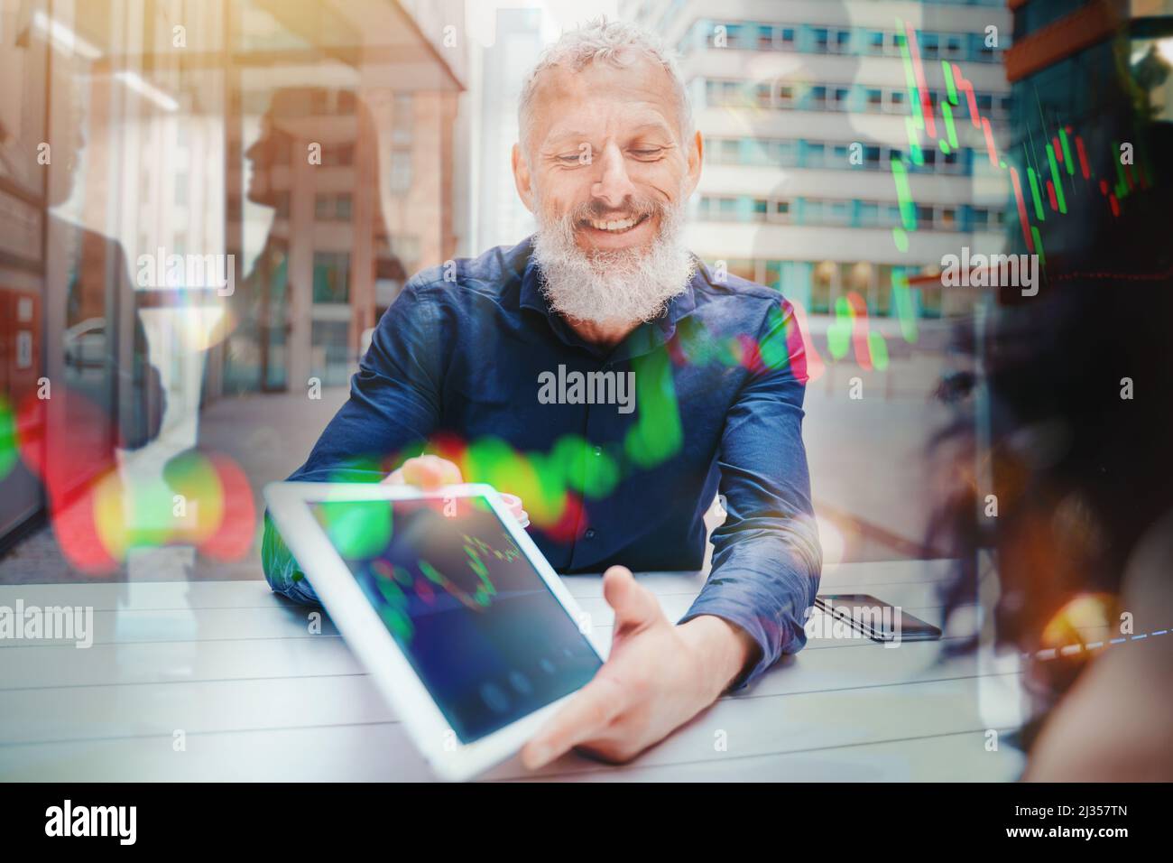 Businessman mostra il grafico del mercato azionario di negoziazione su un tablet Foto Stock