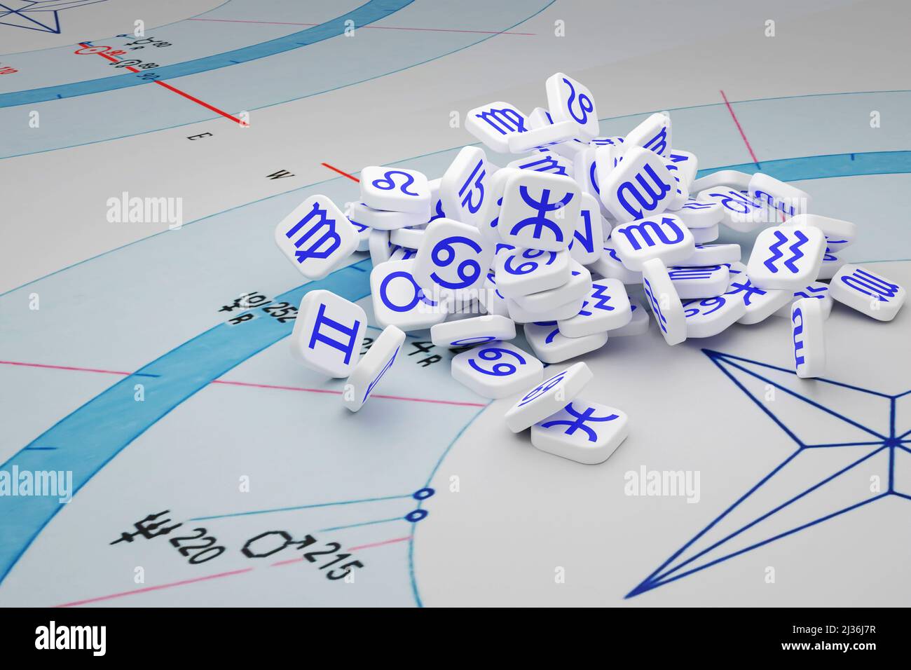 Un mazzo di piastrelle bianche con icone blu di segni zodiacali su una carta astrologica. Foto Stock