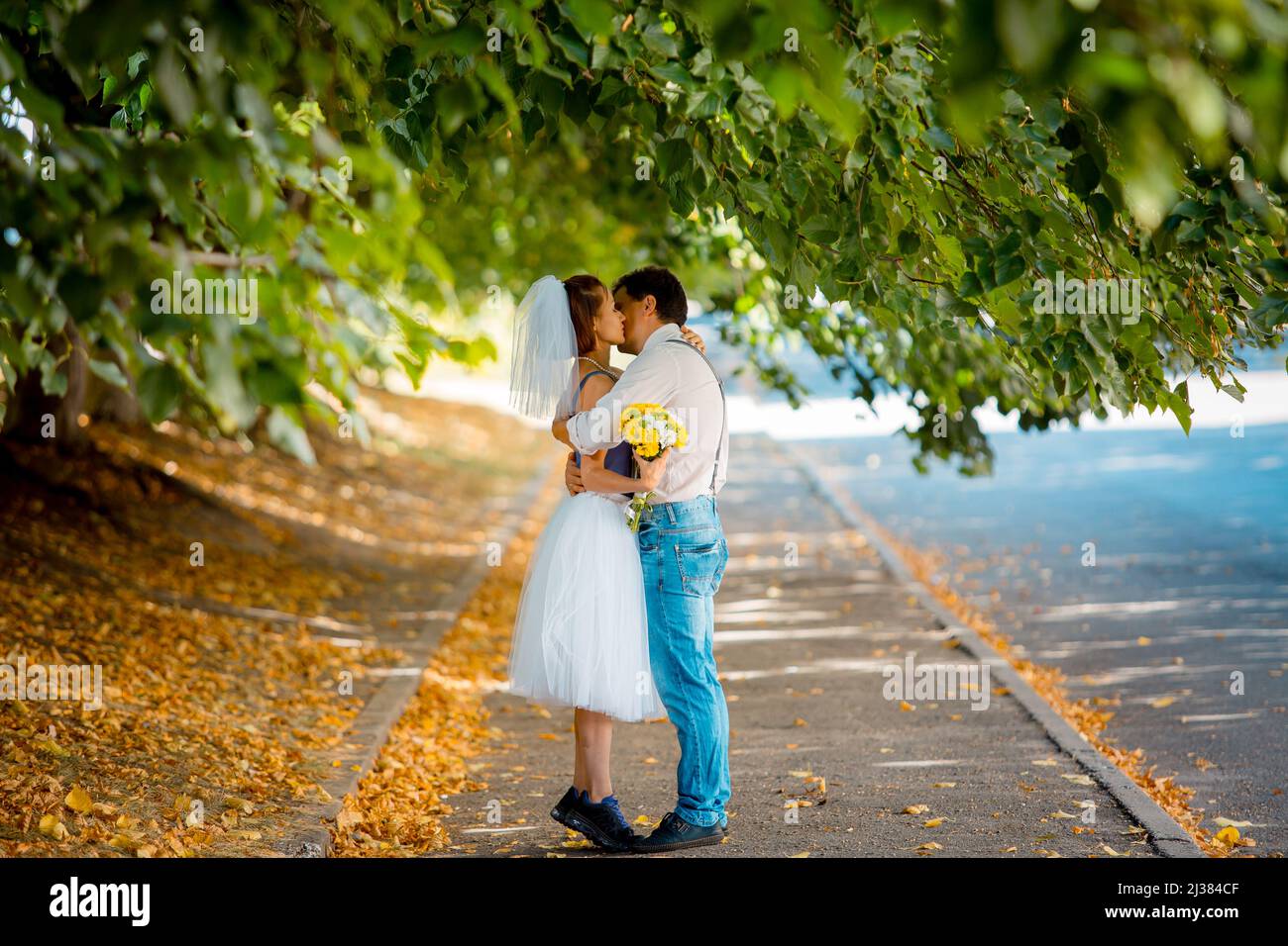 Ritratto di una giovane coppia in abito da sposa che celebra il loro anniversario di matrimonio. Sorridi, bacia, amore. Foto Stock