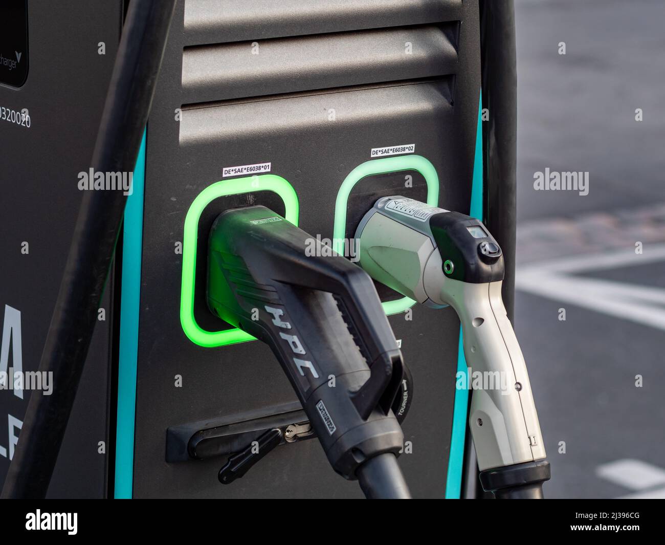 Connettore di una stazione di carica elettrica. Spina per ricaricare un veicolo elettrico come un'auto. Primo piano di un caricabatteria con cavi pesanti. Foto Stock