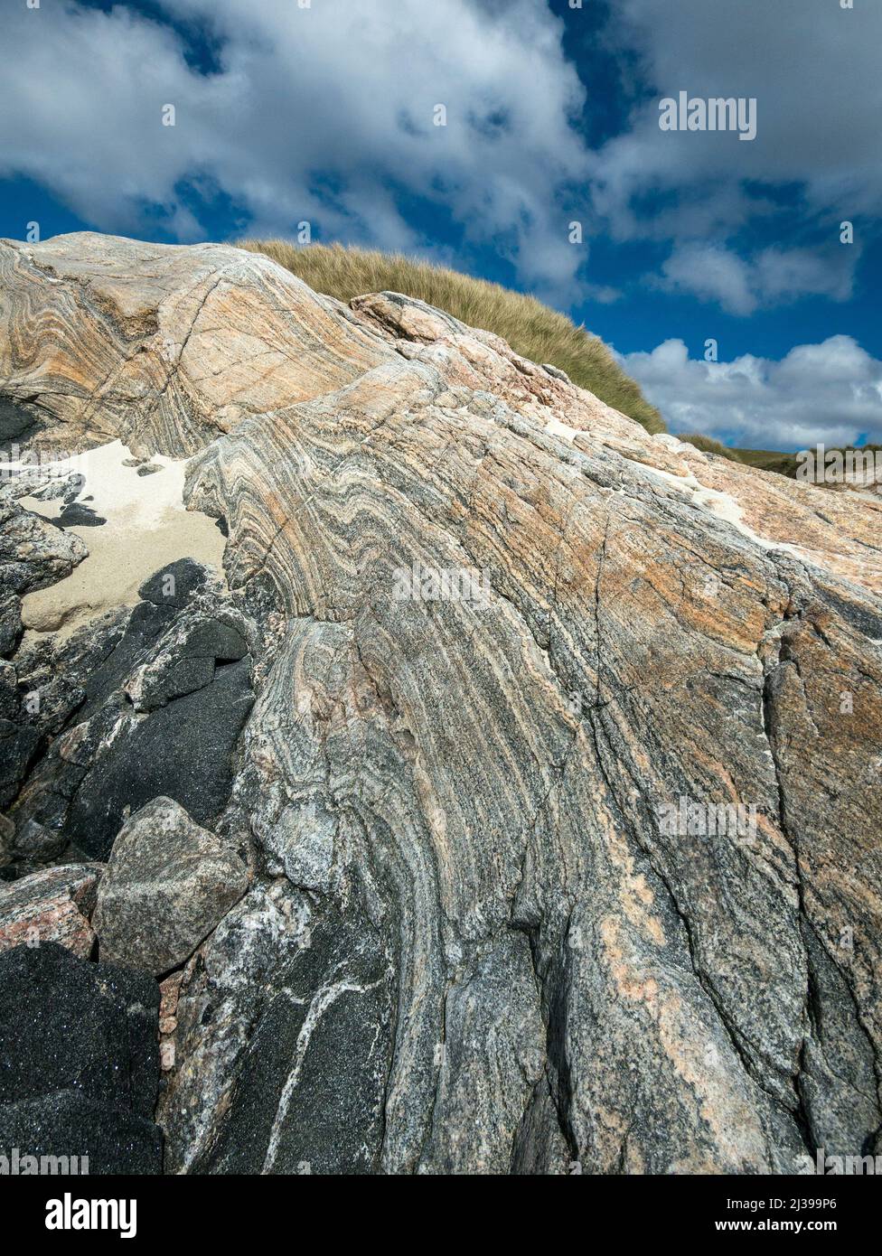 Bella formazione di roccia colorata a fasce di Gneiss Lewisian sulla spiaggia di Traigh Mheilein vicino a Hushinish sull'isola di Harris, Scozia, Regno Unito Foto Stock