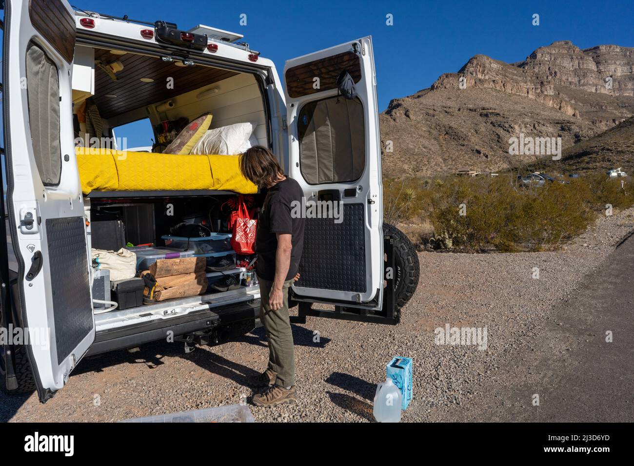 Un uomo sta impacchettando il suo camper mentre fa una pausa al Big Bend Ranch state Park nel Texas meridionale vicino al confine del Messico Foto Stock