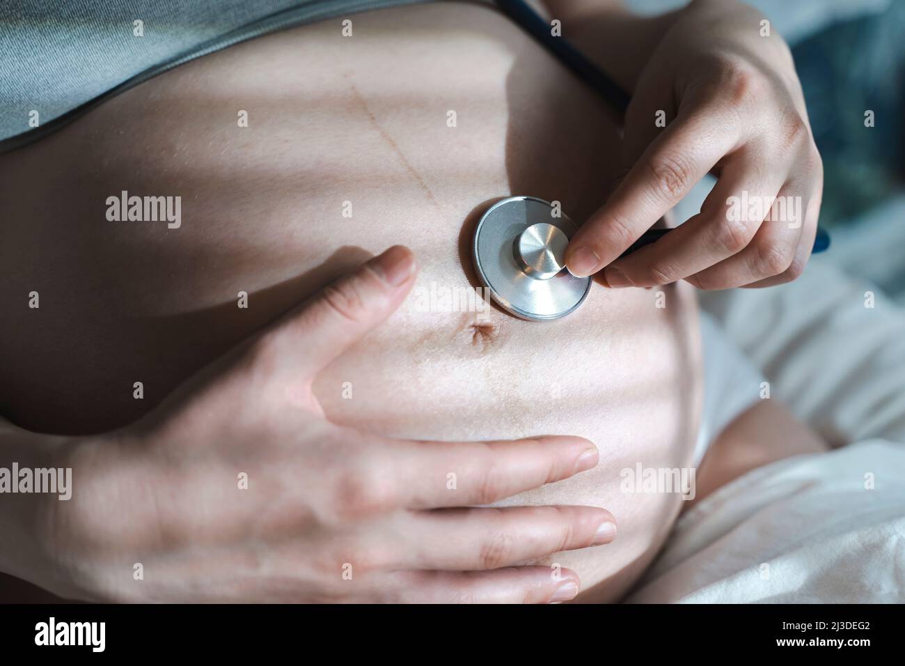La donna incinta ascolta il battito cardiaco del bambino e i movimenti con  uno stetoscopio o fetoscopio