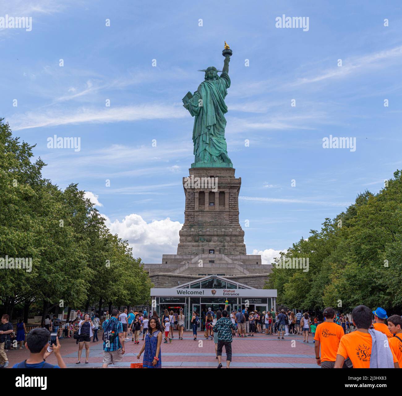 Liberty Island, New York, NEW York, USA, una vista inaspettata della famosissima Statua della libertà a New York. Catturato contro un cielo drammatico. Foto Stock