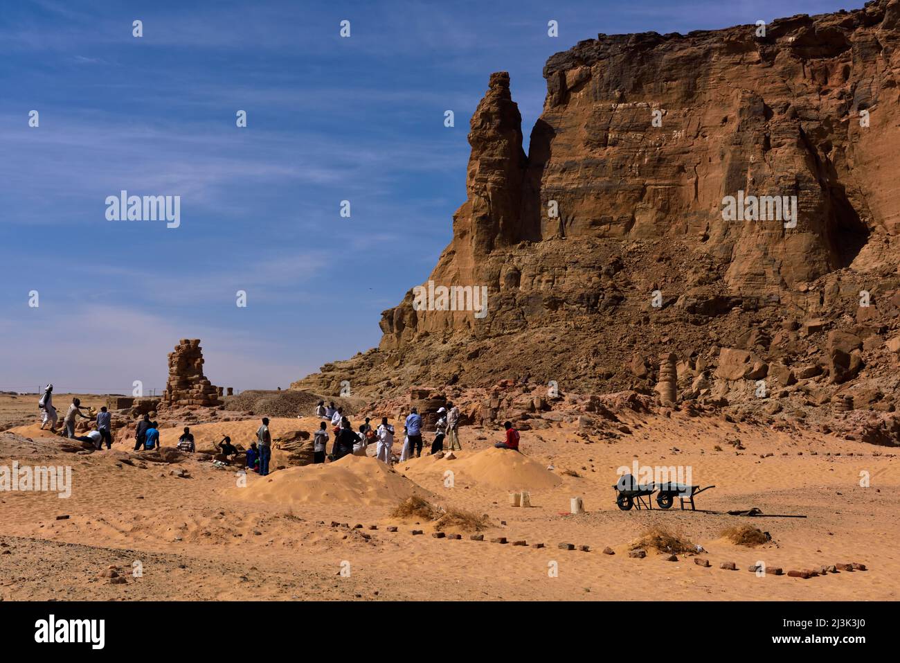 Lavoratori sudanesi al tempio di Amun, che si trova ai piedi dell'altopiano di Jebel Barkal. Egiziani e Nubiani credevano la forma dell'altopiano, resem Foto Stock