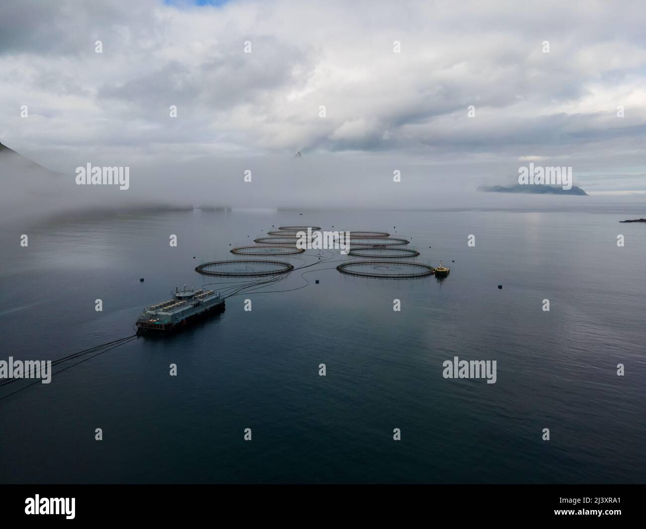 Belle riprese aeree cinematografiche delle piscine della fattoria di pesca al salmone e della barca nelle isole Faroe Foto Stock