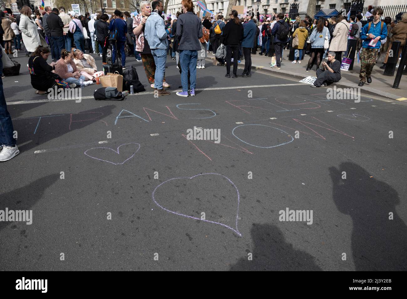 Londra, Regno Unito. 10th Apr 2022. Durante la dimostrazione viene scritto uno slogan con gesso sul pavimento. I sostenitori della Trans Right protestano al di fuori di Downing Street contro la decisione del governo britannico di non vietare le terapie di conversione trans. Credit: SOPA Images Limited/Alamy Live News Foto Stock