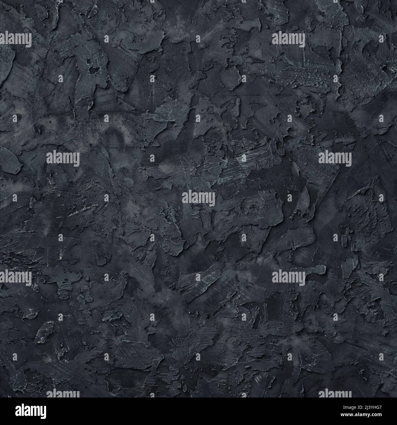 Tessuto di gesso nero. Sfondo nero della parete in stucco. Vista dall'alto. Foto Stock