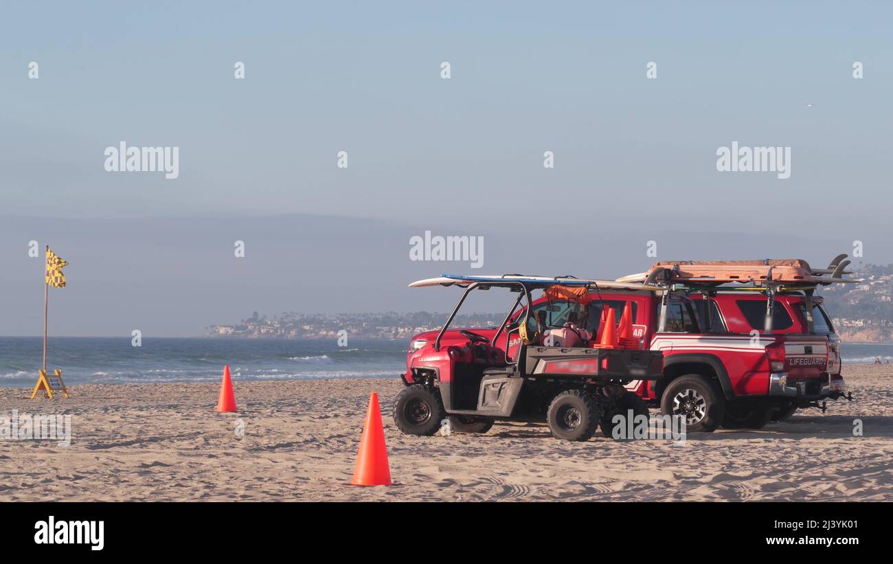 Bagnino rosso pick-up camion, salvavita auto sulla sabbia, California oceano spiaggia Stati Uniti. Soccorso pick up auto sulla costa per la sicurezza del surf, salvatori 911 veicolo, cielo e onde di mare. Cinematografia senza giunture. Foto Stock