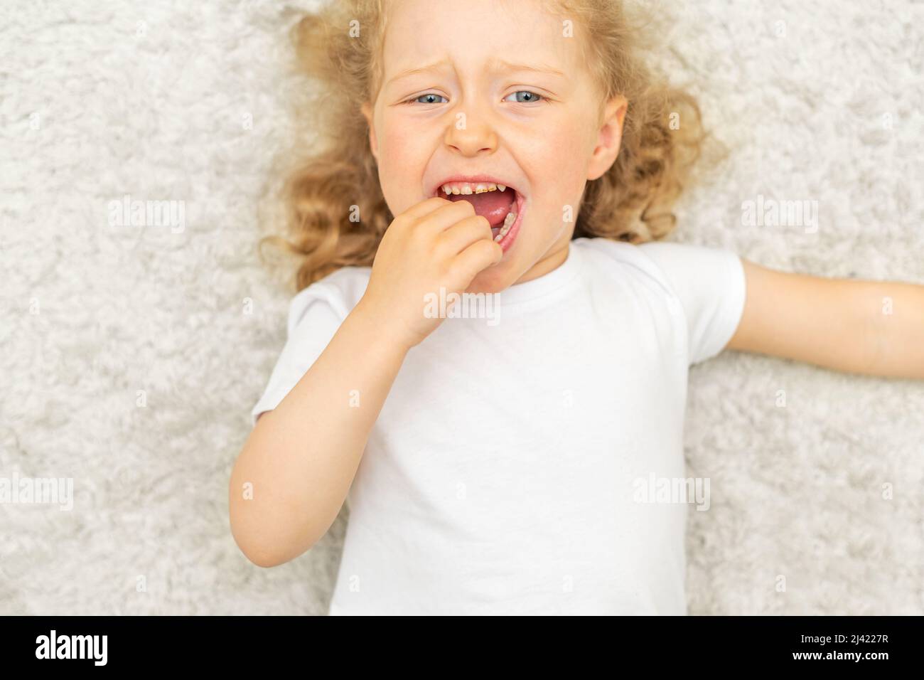 Il bambino ha un mal di denti. Carie per bambini. Foto Stock