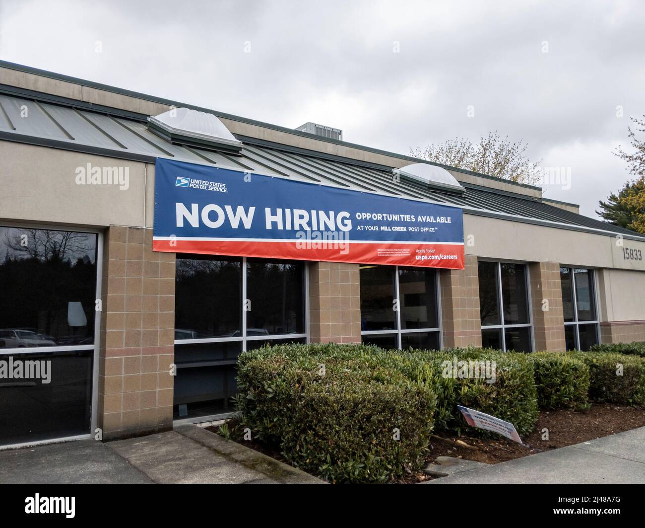 Mill Creek, WA USA - circa Aprile 2022: Vista di un cartello Now Hiring all'esterno dell'edificio Mill Creek United States Postal Service. Foto Stock