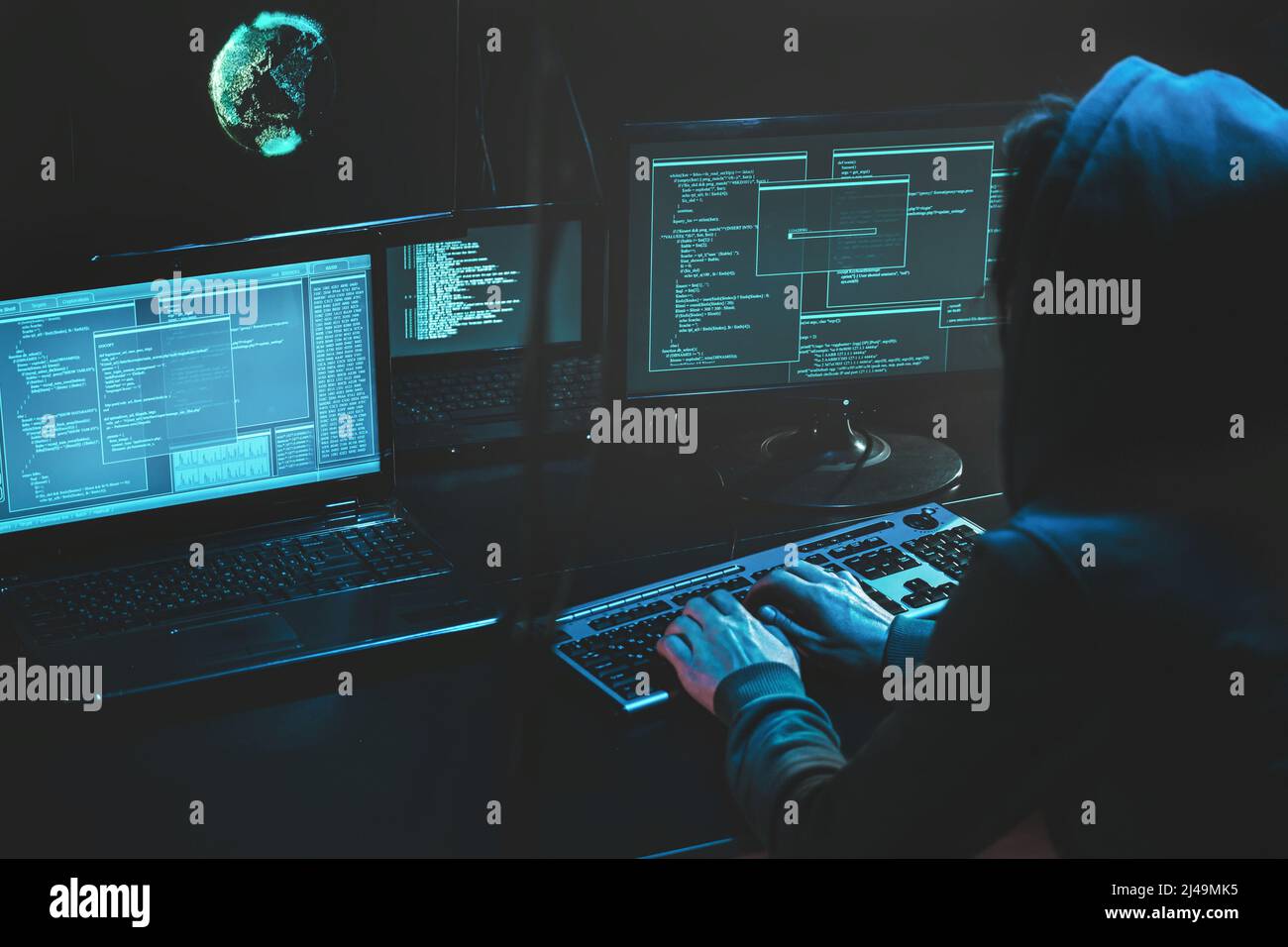 Sistema di hacking criminale informatico a monitor, hacker attacca i server web in una stanza buia al computer con monitor che inviano virus utilizzando la vulnerabilità della posta elettronica Foto Stock