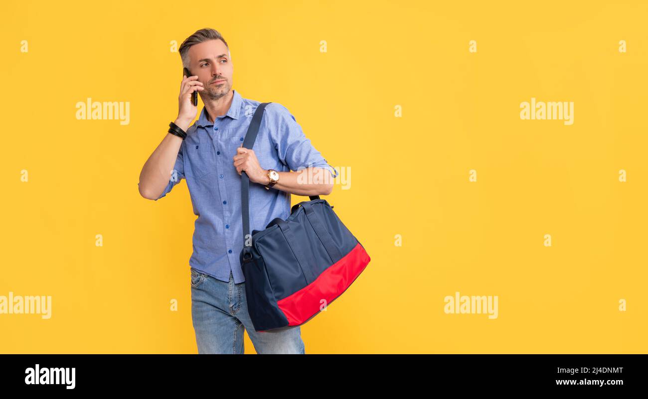 uomo ha conversazione tenere borsa sport. telefono chiamata negoziazione. Foto Stock