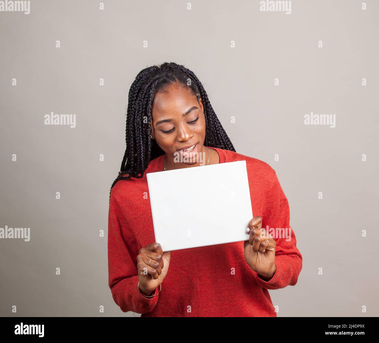 African American donna con occhi blu tenendo un cartello con una stanza per la copia. L'immagine pubblicitaria con camera per la copia Foto Stock