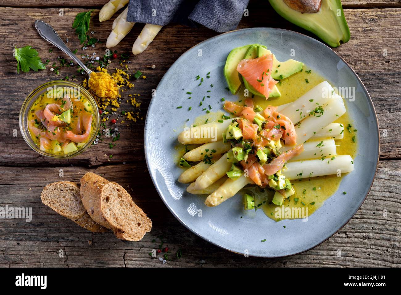Asparagi bianchi freschi con vinaigrette di limone e arancia con avocado e salmone affumicato Foto Stock