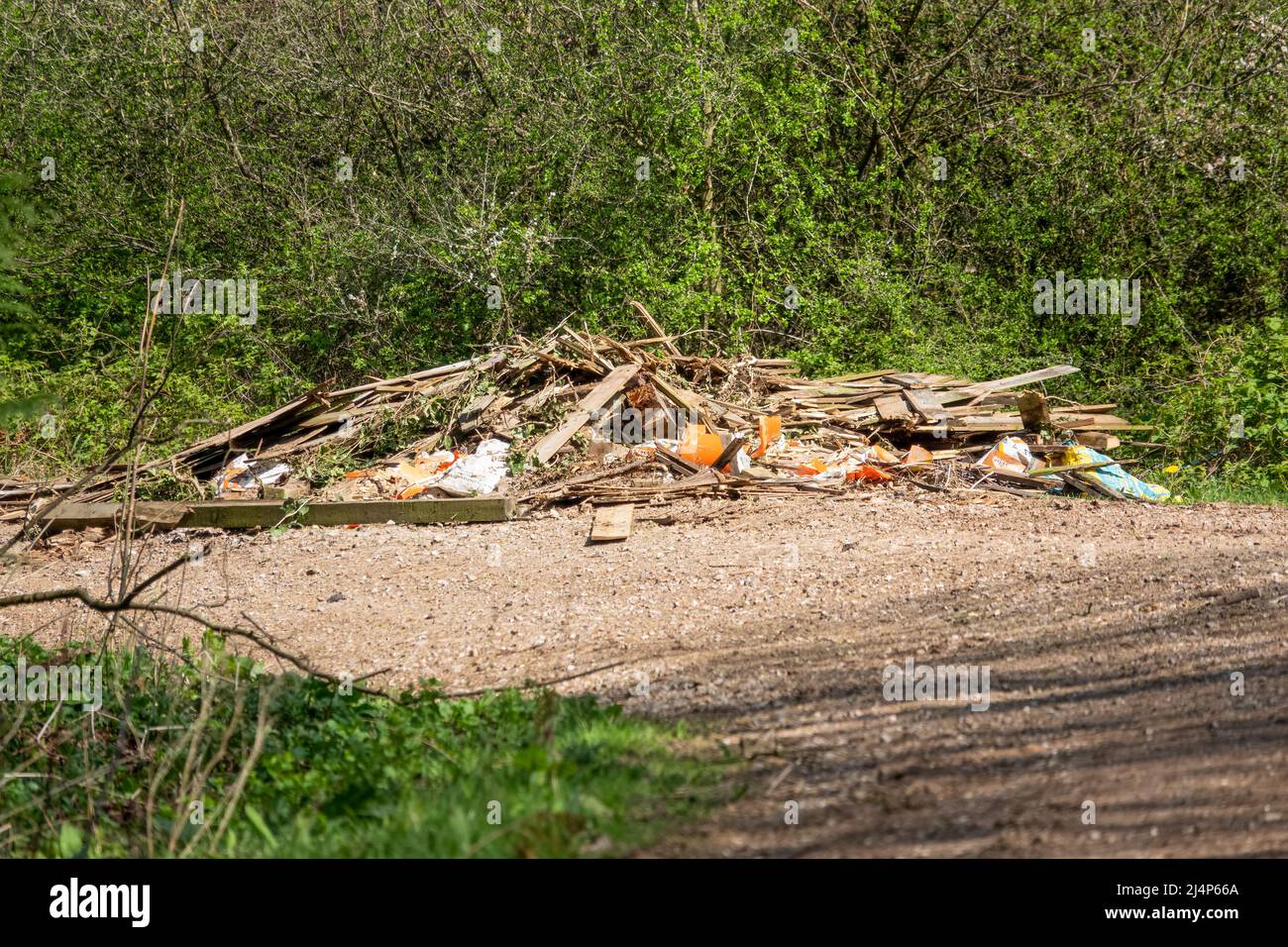 rifiuti di ribaltamento illegale di pannelli di recinzione rimossi, macerie e calcestruzzo su una pista di campagna Foto Stock