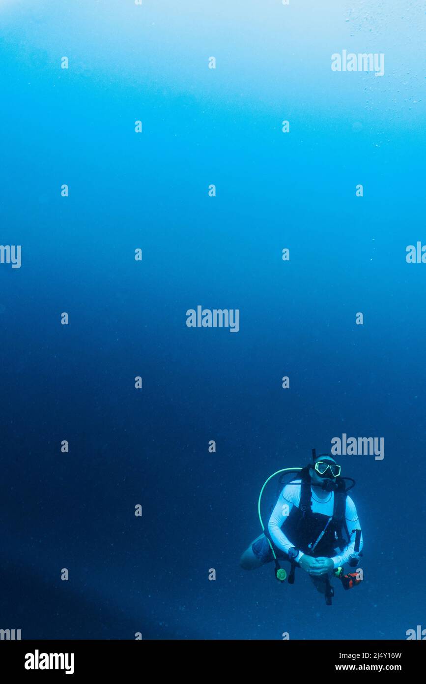 uomo adulto maturo che esplora l'acqua tropicale nelle Maldive Foto Stock