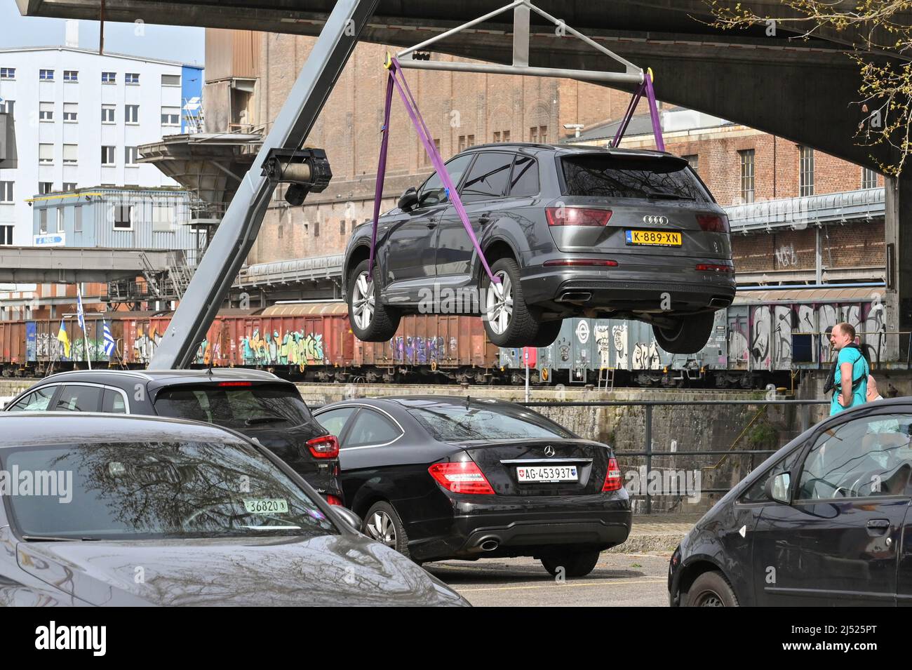 Basilea, Svizzera - Aprile 2022: L'auto Audi viene scaricata da una gru da una chiatta industriale nelle banchine della città sul fiume Reno Foto Stock