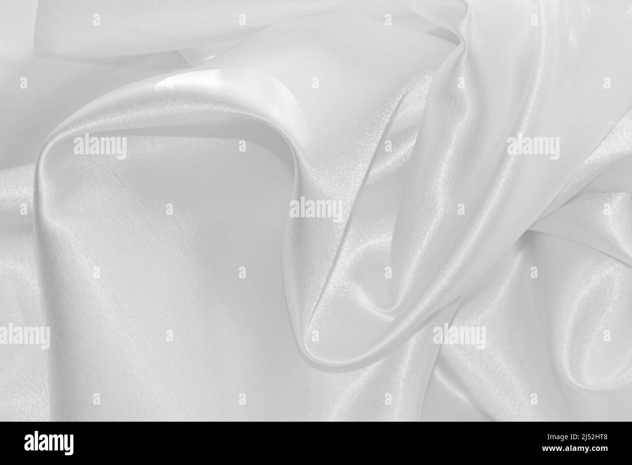Primo piano di fotografia di materiale tessile bianco drappeggiato. Foto Stock