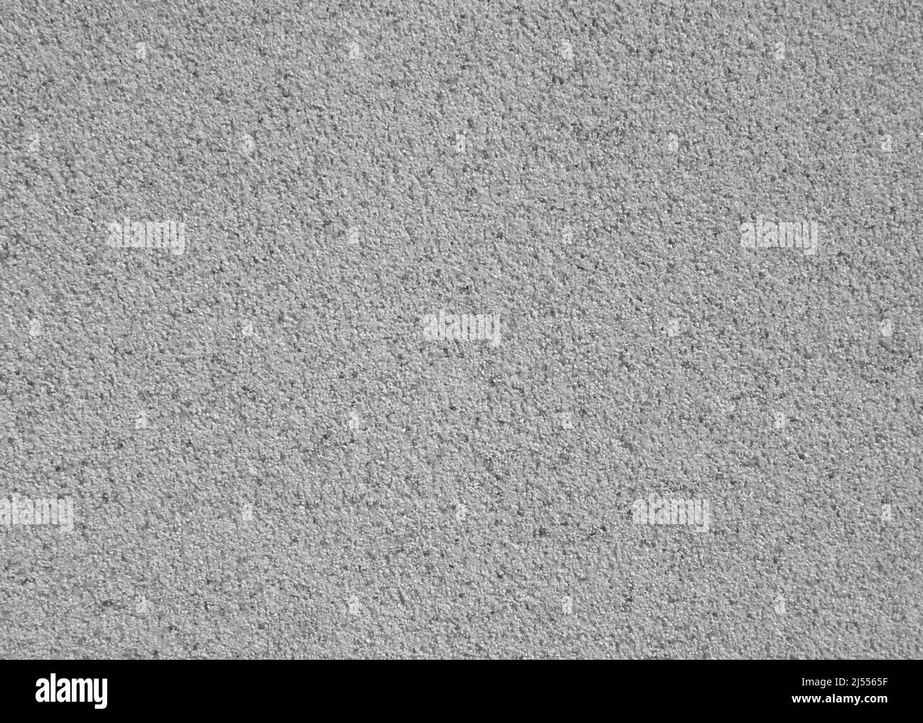 Sfondo parete astratto. Intonaco grigio con motivo a mosaico. Superficie leggera con un modello caotico sciolto. Rivestimento testurizzato a mosaico e granulato Foto Stock