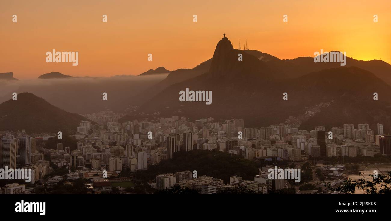 Incredibile tramonto sulla città, visto dal Pan di zucchero, con la statua del Cristo Redentore all'orizzonte. Rio de Janeiro, RJ, Brasile. Foto Stock