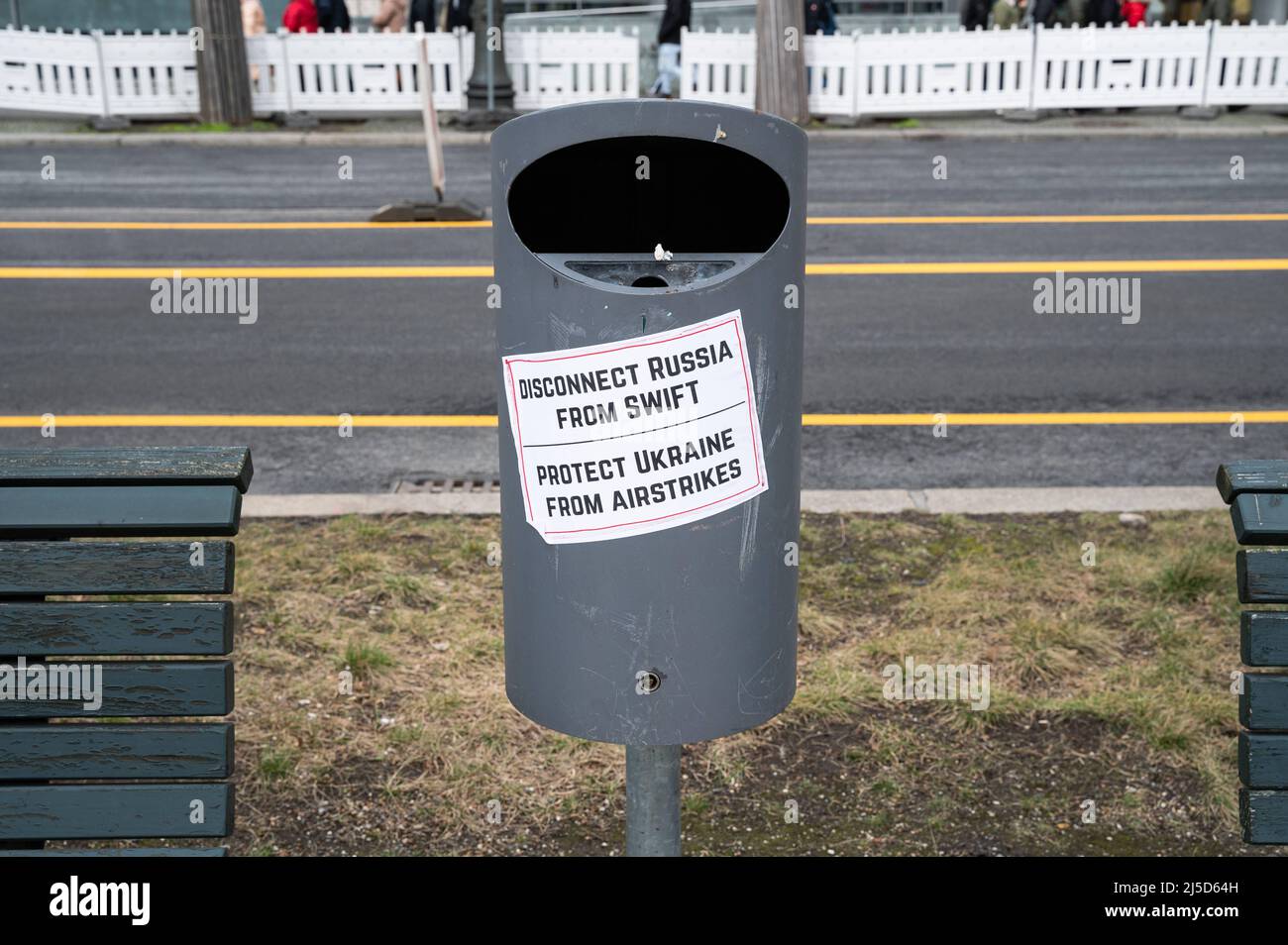 26 febbraio 2022, Berlino, Germania, Europa - un adesivo con le parole Disconnetti la Russia da Swift - proteggere l'Ucraina dagli attacchi aerei è bloccato in un cestino tra due banchi di fronte all'ambasciata russa Unter den Linden nel distretto di Mitte ed è diretto contro le politiche del presidente russo Putin e del Guerra in Ucraina dopo l'invasione dei soldati russi. [traduzione automatizzata] Foto Stock