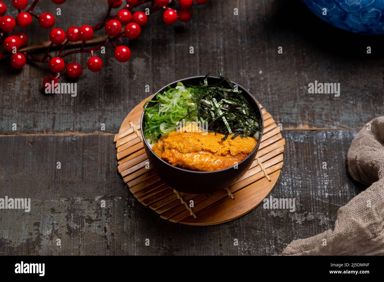 Sea Urchin Chawanmushi in un piatto con bacchette isolate su stuoia vista laterale su tavola di legno taiwan cibo Foto Stock