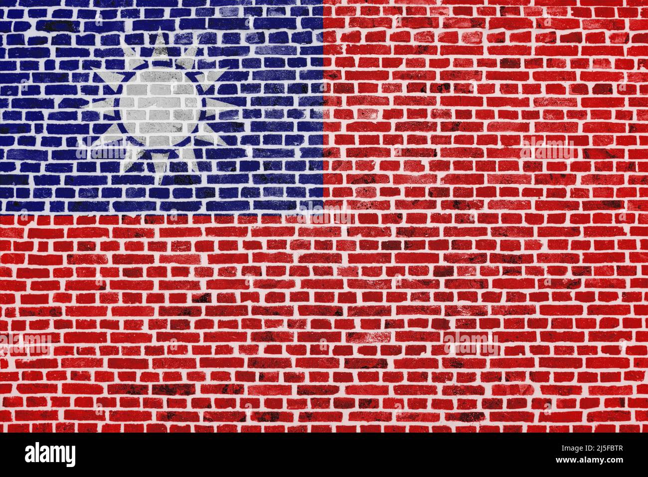 Primo piano su un muro di mattoni con la bandiera di Taiwan dipinta su di esso. Foto Stock