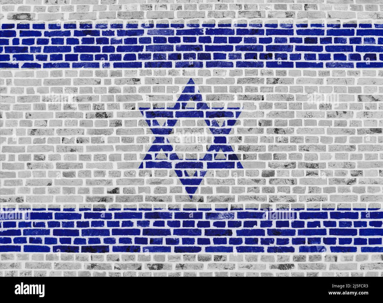 Primo piano su un muro di mattoni con la bandiera di Israele dipinta su di esso. Foto Stock