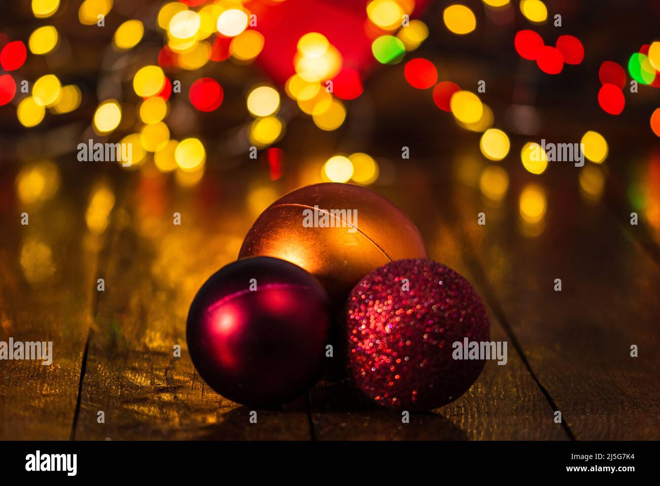 Le decorazioni di Natale contro sfondo sfocato e fuori fuoco luci. Close up di glittery palle di Natale Foto Stock