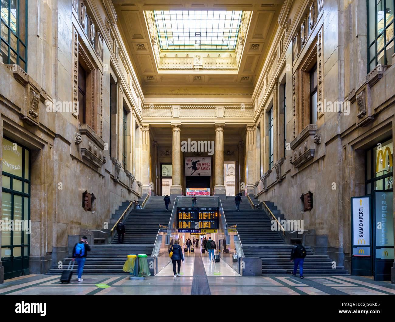 I viaggiatori stanno prendendo una monumentale doppia scala nella stazione ferroviaria di Milano Centrale, a Milano, Italia. Foto Stock