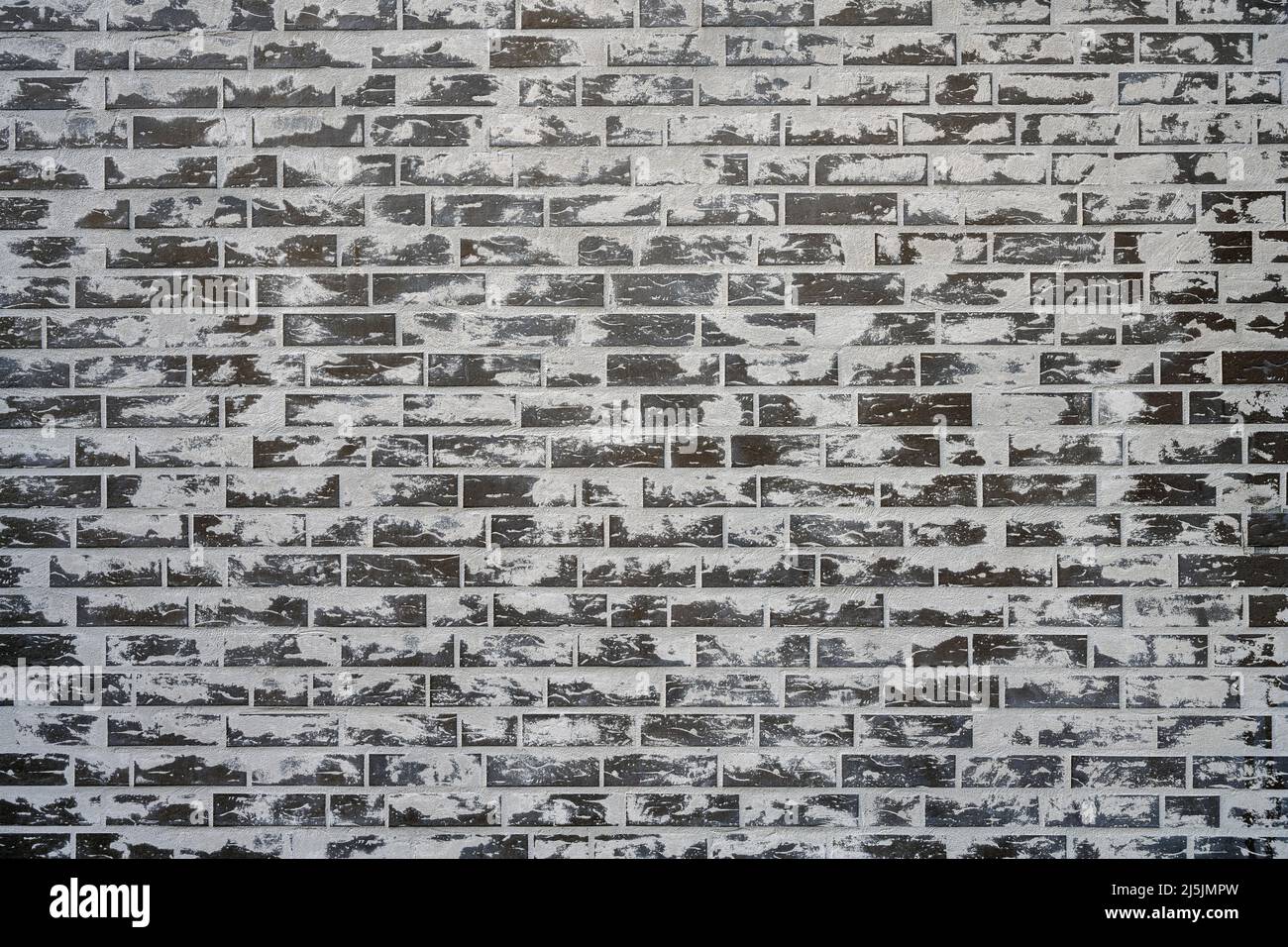 Sfondo da un muro di mattoni grigi con un sacco di cemento sulla superficie Foto Stock