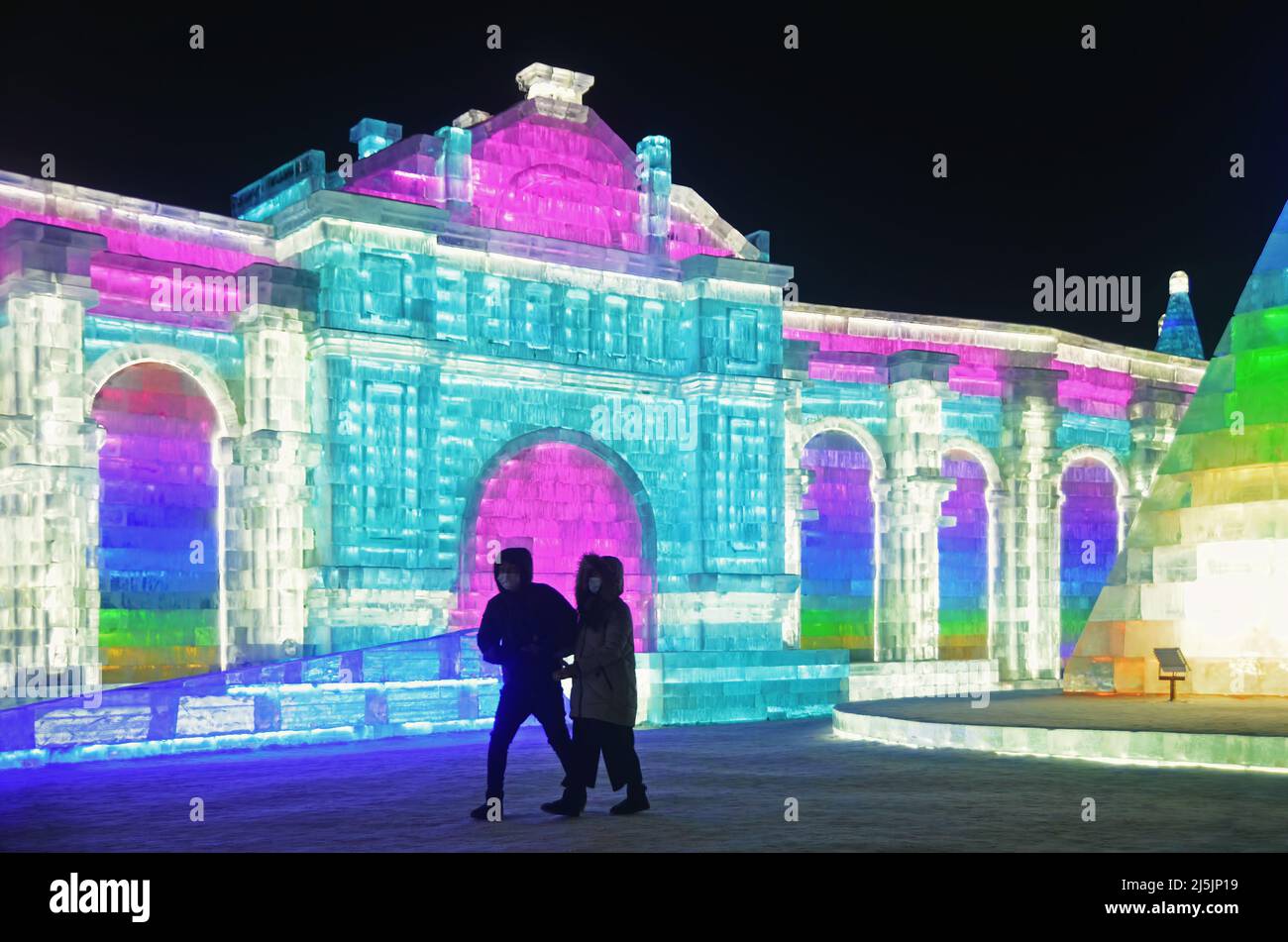 I turisti si godono le sculture di ghiaccio colorate in Harbin International Ice and Snow Sculpture Festival (Ice & Snow World) Foto Stock