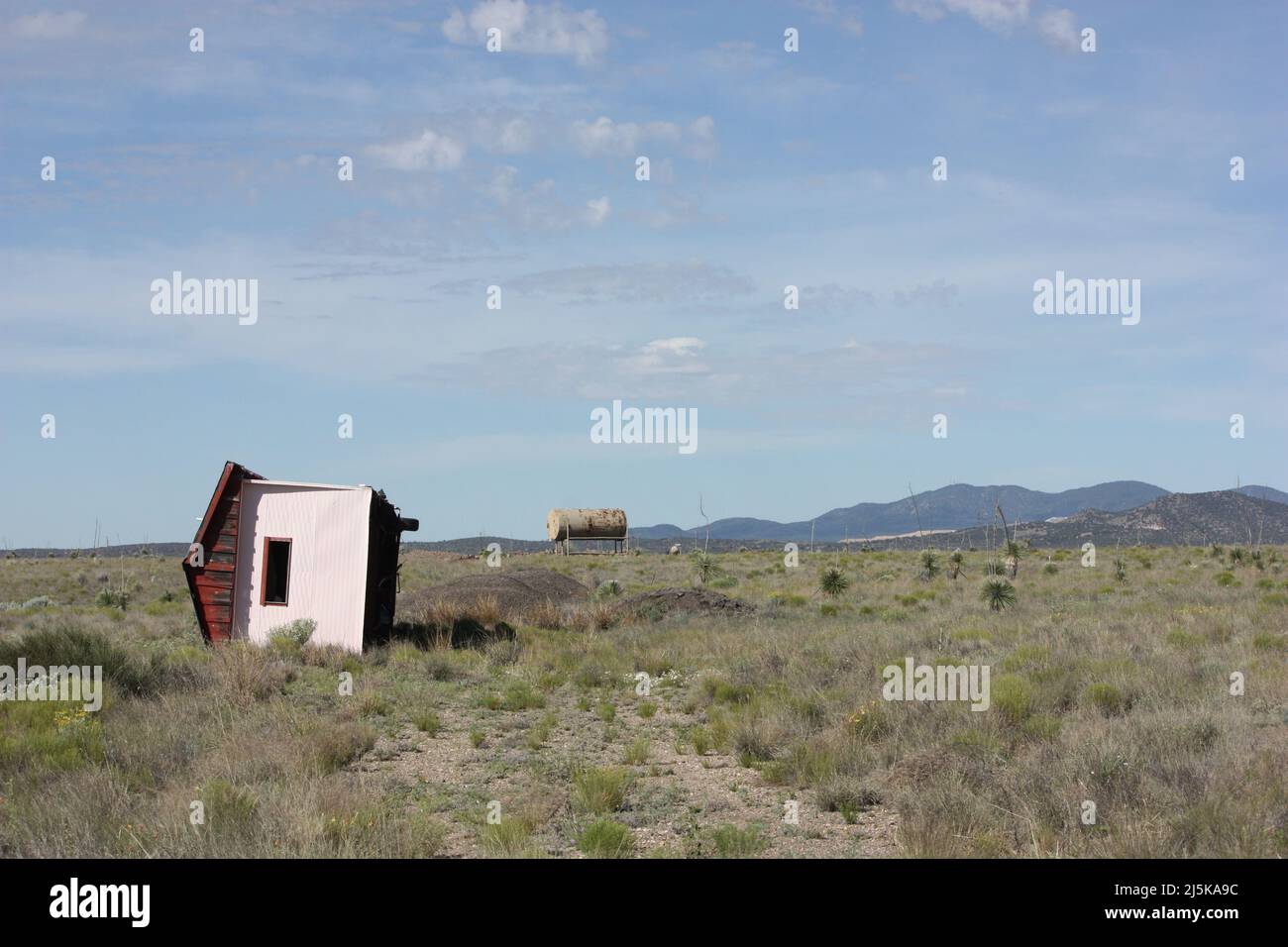 Rimorchio della casa disposto lateralmente sulla proprietà abbandonata del deserto Foto Stock