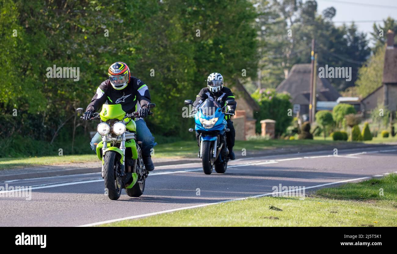 Due moto che attraversano un tranquillo villaggio inglese Foto Stock