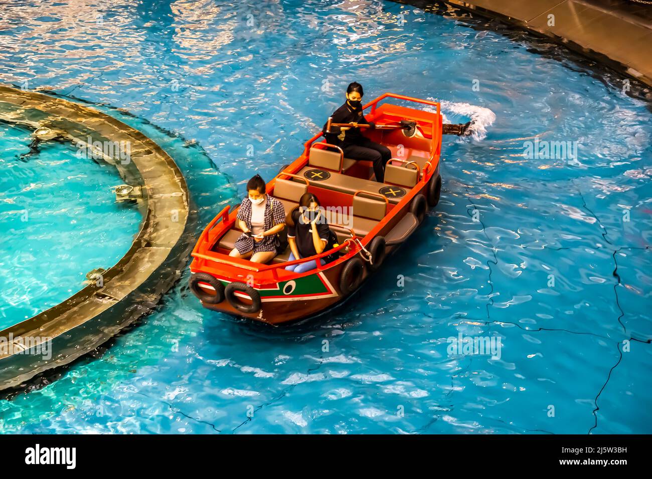 Giro in sampan lungo il canale presso lo Shoppes a Marina Bay Sands in una barca Sampan splendidamente artigianale. Foto Stock