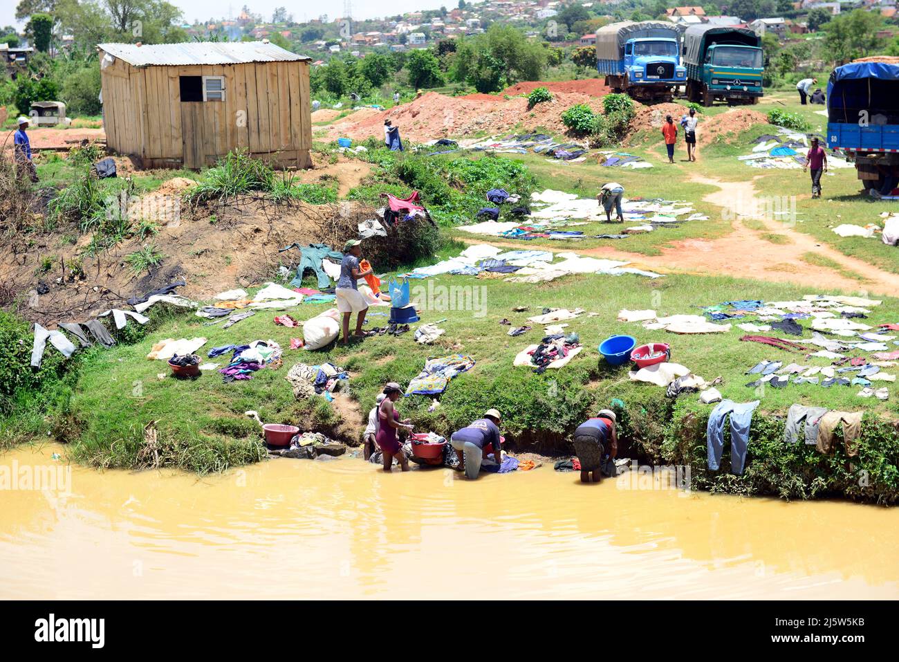 Le donne malgasce lavano i vestiti nel fiume. Highlands centrali, Madagascar. Foto Stock