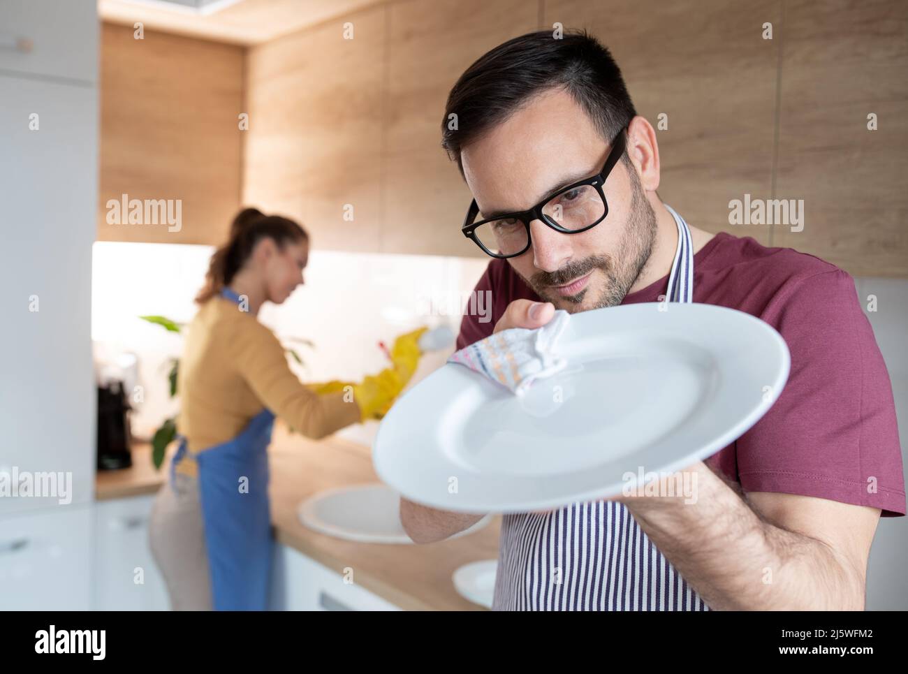 Lavare i piatti in cucina - giallo e blu - guanti di plastica con un sacco  di schiuma - Maschio lavando i piatti in cucina zona lavandino - vista  superiore Foto stock - Alamy