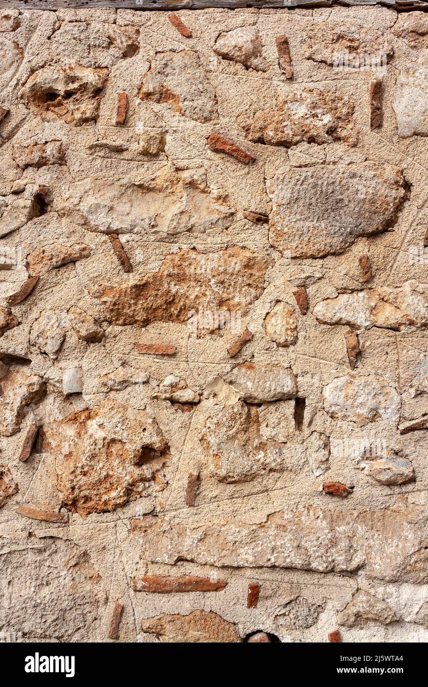 Vecchio muro da pietre grandi e piccole all'interno di Malta di cemento. Foto Stock