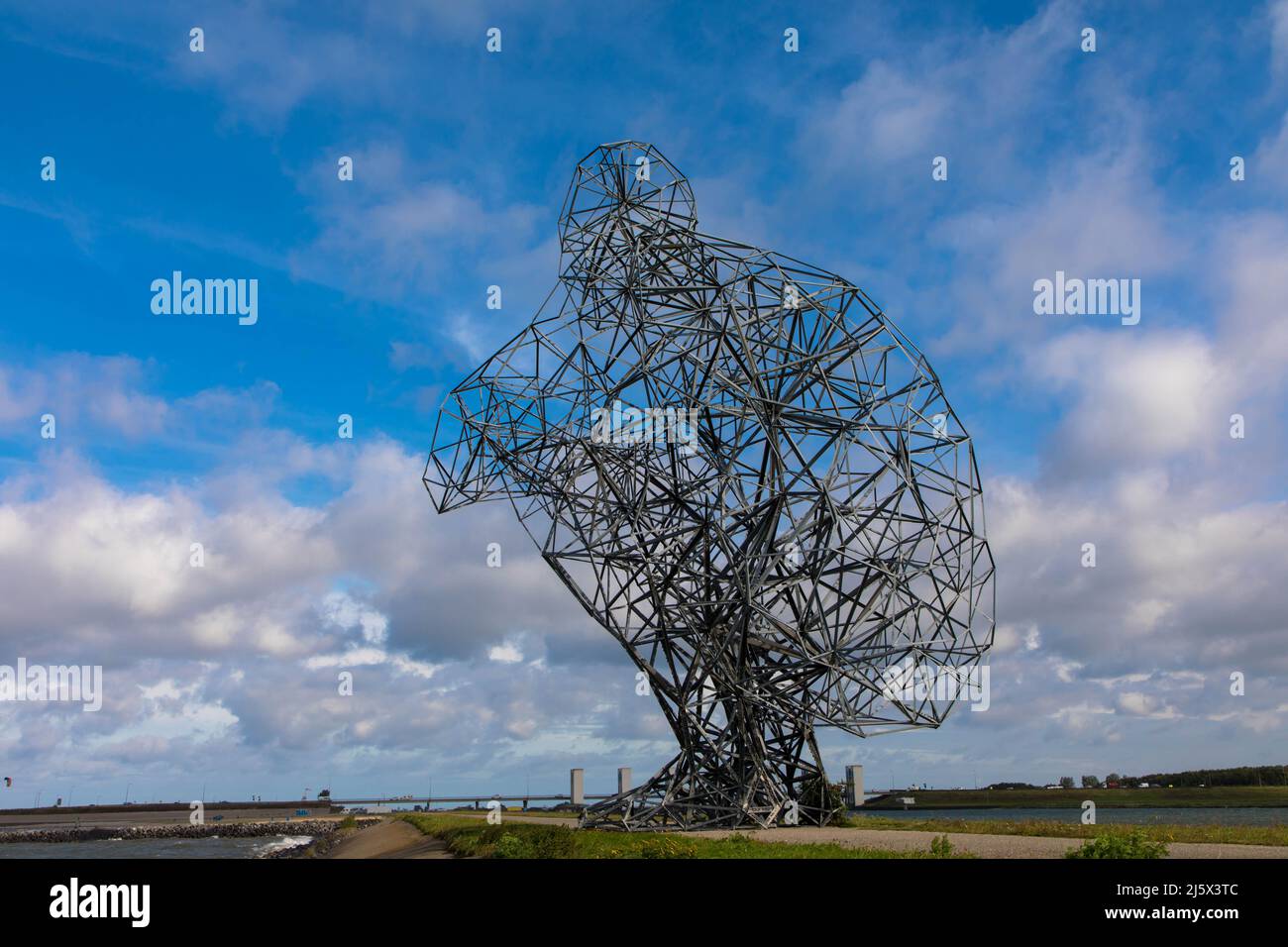 Primo piano della gigantesca opera d'arte dell'acciaio grande. Uomo che sbatte seduto alla diga del lago di Markermmer. Esposizione da Antony Gormley 2021 settembre Foto Stock