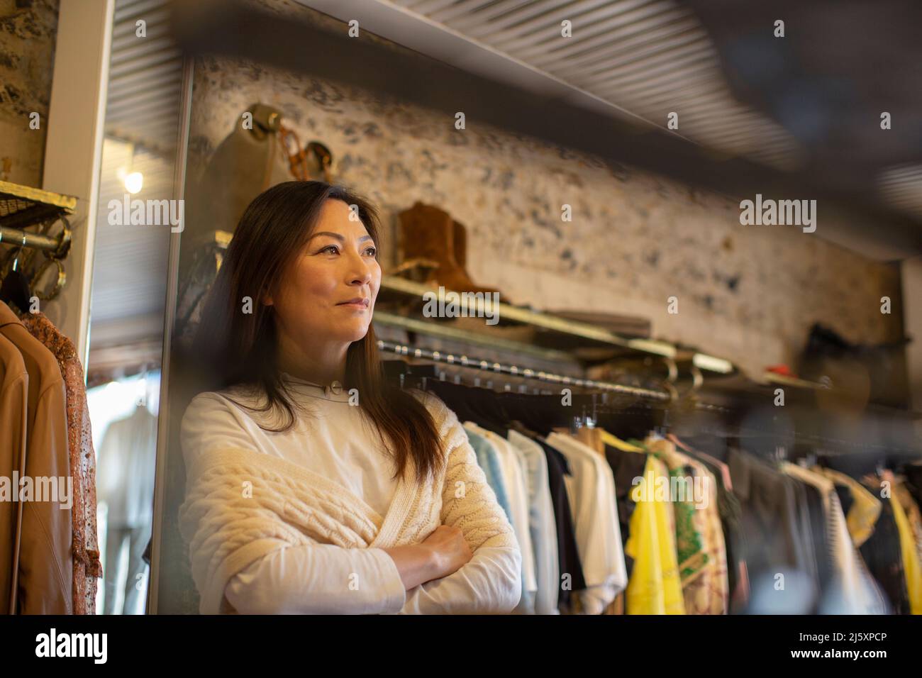 Premuroso proprietario donna in boutique di abbigliamento Foto Stock