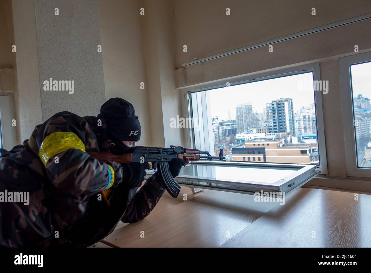 KIEV, UCRAINA 02 marzo. Un membro del battaglione di difesa di Kyiv punta il fucile da un piano superiore di un edificio di uffici, mentre i funzionari temono che i sabotatori russi attaccheranno le infrastrutture della città e causeranno panico durante l'invasione russa dell'Ucraina il 02 marzo 2022 a Kiev, Ucraina. La Russia ha iniziato un'invasione militare dell'Ucraina dopo che il parlamento russo ha approvato trattati con due regioni separatiste nell'Ucraina orientale. E' il più grande conflitto militare in Europa dalla seconda guerra mondiale Foto Stock