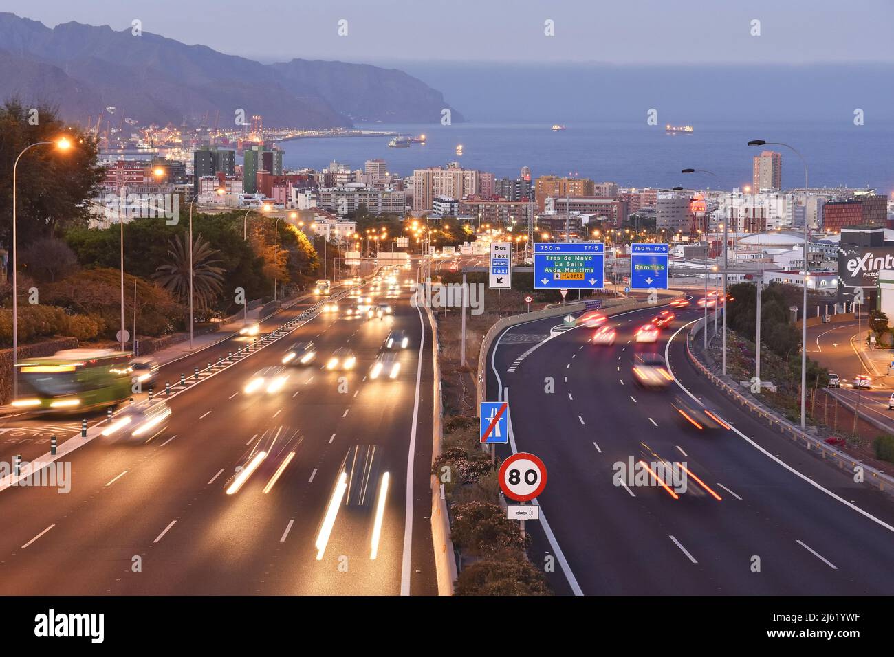 Autostrada Autopista TF-5 che si avvicina alla città di Santa Cruz de Tenerife al crepuscolo, Isole Canarie Spagna. Foto Stock