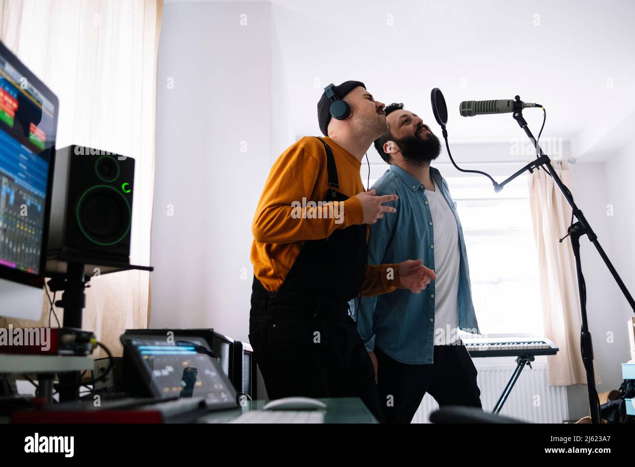 Musicisti che cantano insieme al microfono a casa Foto Stock