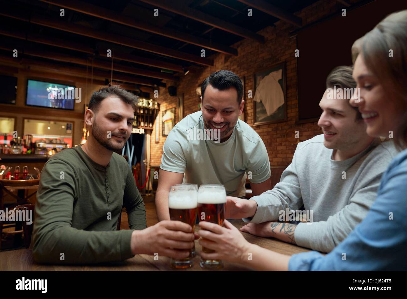 Amici che si incontrano in un pub e calici bicchieri da birra Foto Stock
