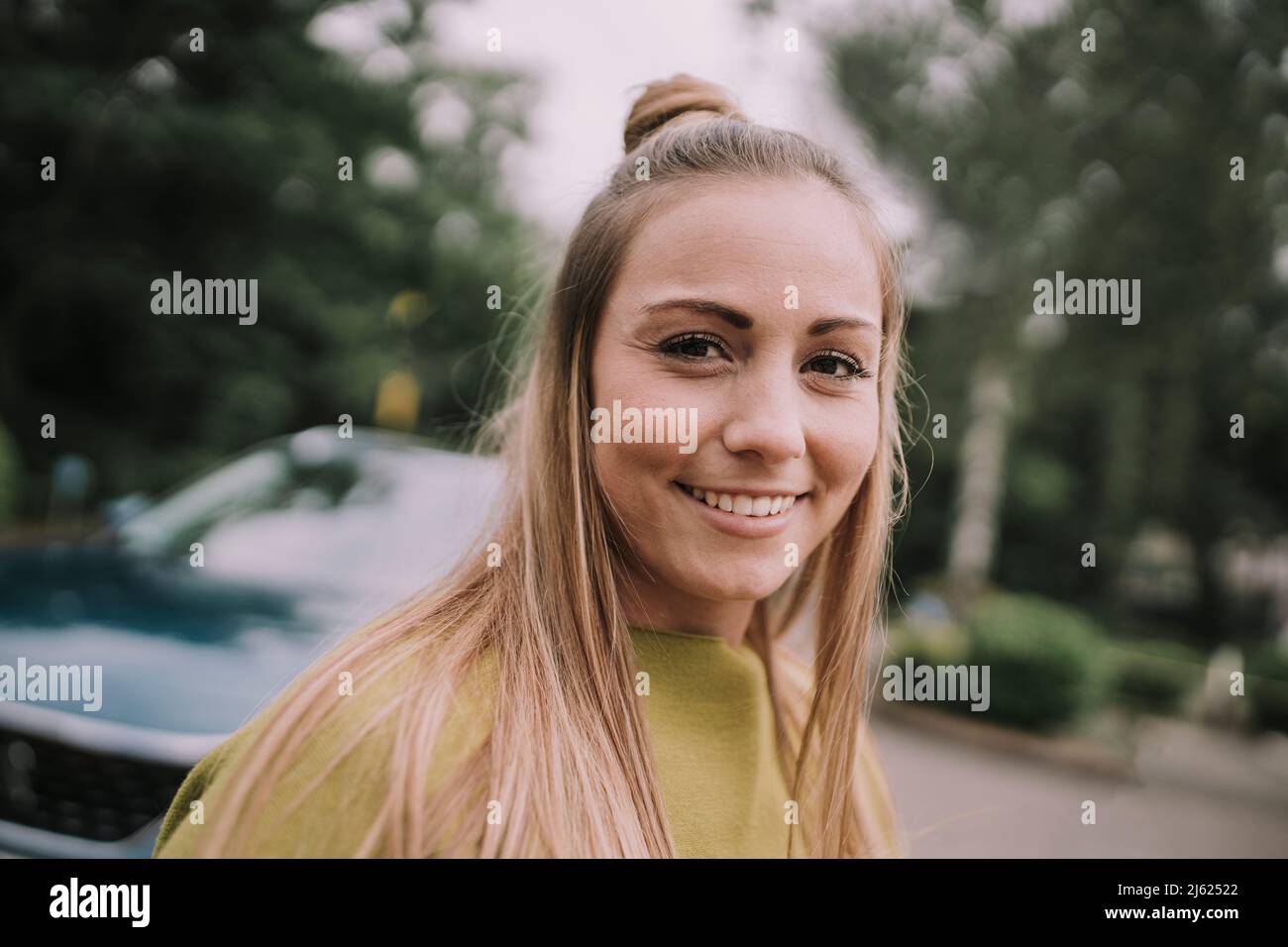 Giovane donna sorridente con capelli biondi Foto Stock