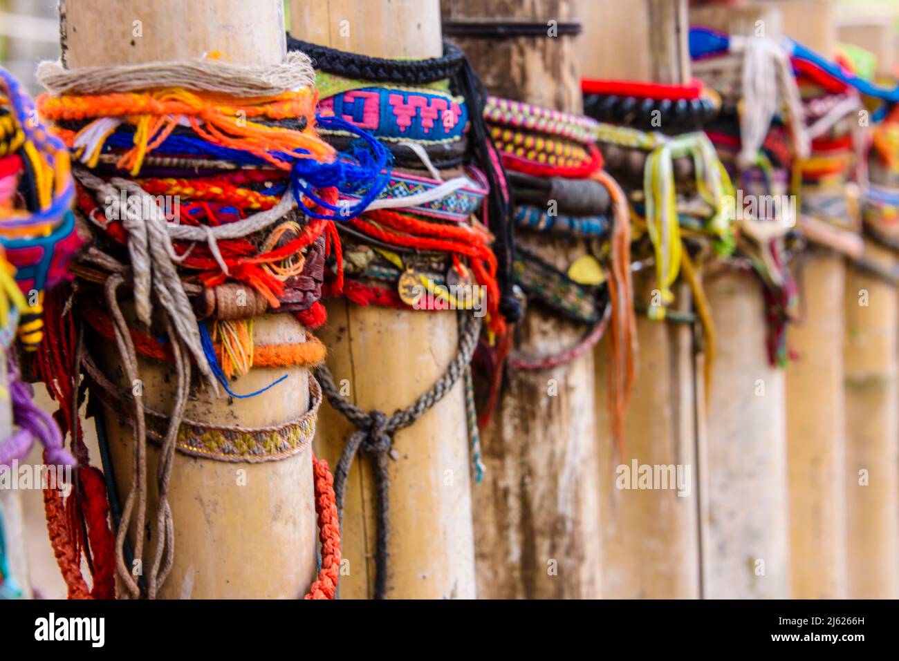 Bracciali colorati lasciati dai visitatori sul sito di una tomba di massa, Choeung Ek Killing Fields Genocide Center, Phnom Penh, Cambogia, sito dove decine di Foto Stock