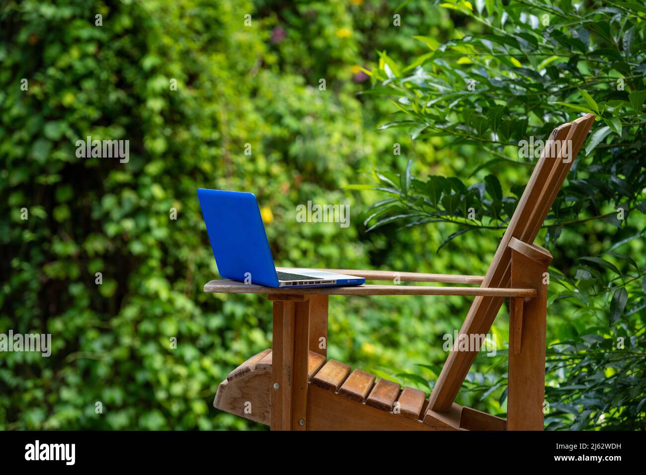 Un computer portatile su una sedia Adirondack in un Lodge della foresta pluviale, Digital Nomad Concept, provincia di Chiriqui, Panama, America Centrale Foto Stock